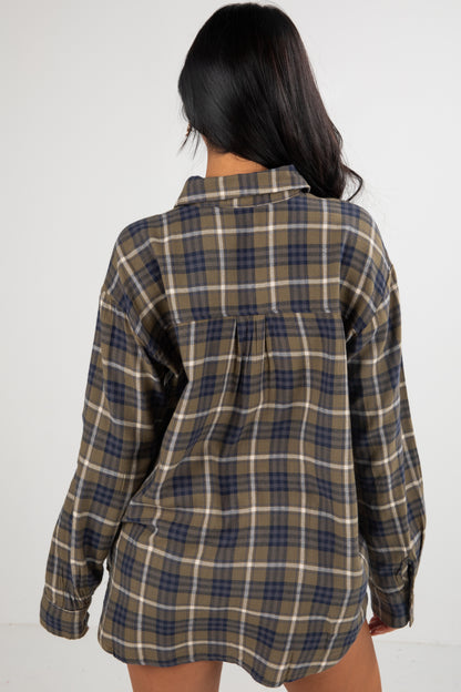 Person wearing a plaid shirt with a white background