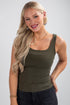 Woman wearing an olive green tank top against a plain background
