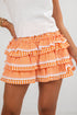 Orange and white checkered ruffled skirt worn by a person on a plain background