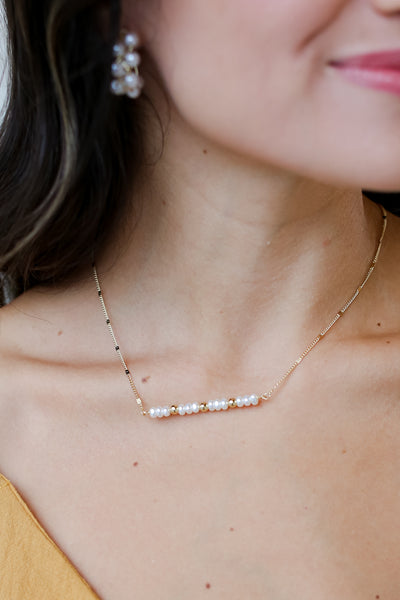 Gold Pearl Bar Necklace on model