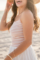 Woman in a striped tank on a beach