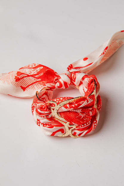 Red and white patterned hair ties on a light gray background