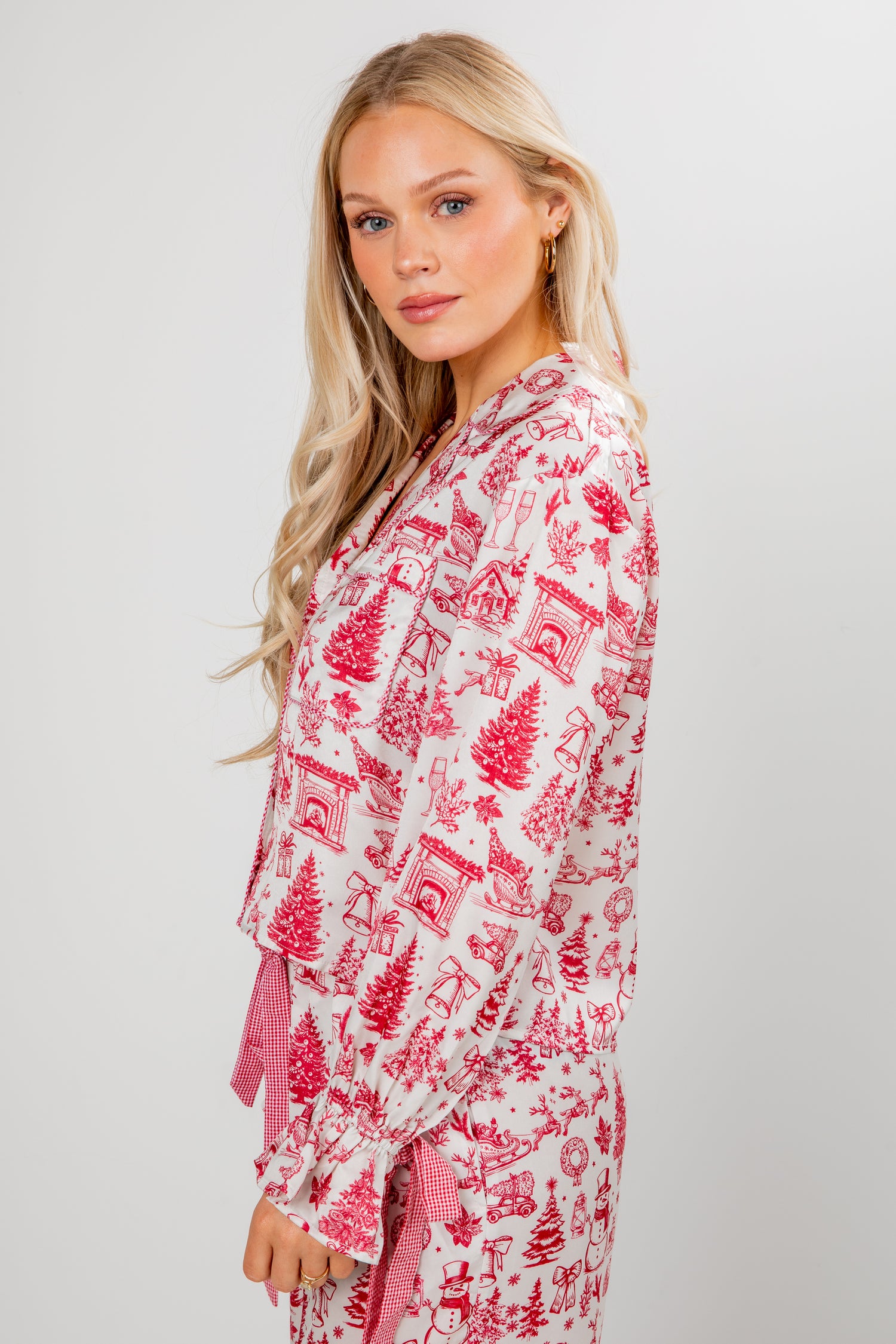 Woman wearing a red and white patterned robe on a plain background