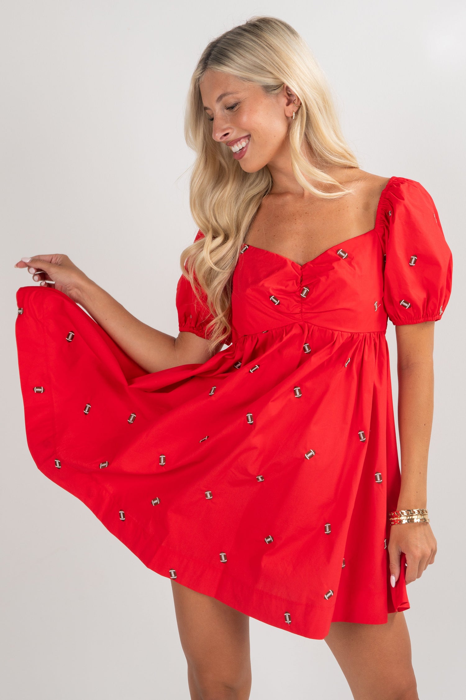 Woman wearing a red dress with puff sleeves on a white background