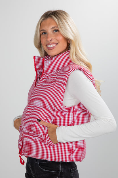 Woman wearing a red checkered vest on a white background