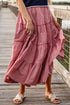 Person wearing a red checkered skirt on a wooden bridge
