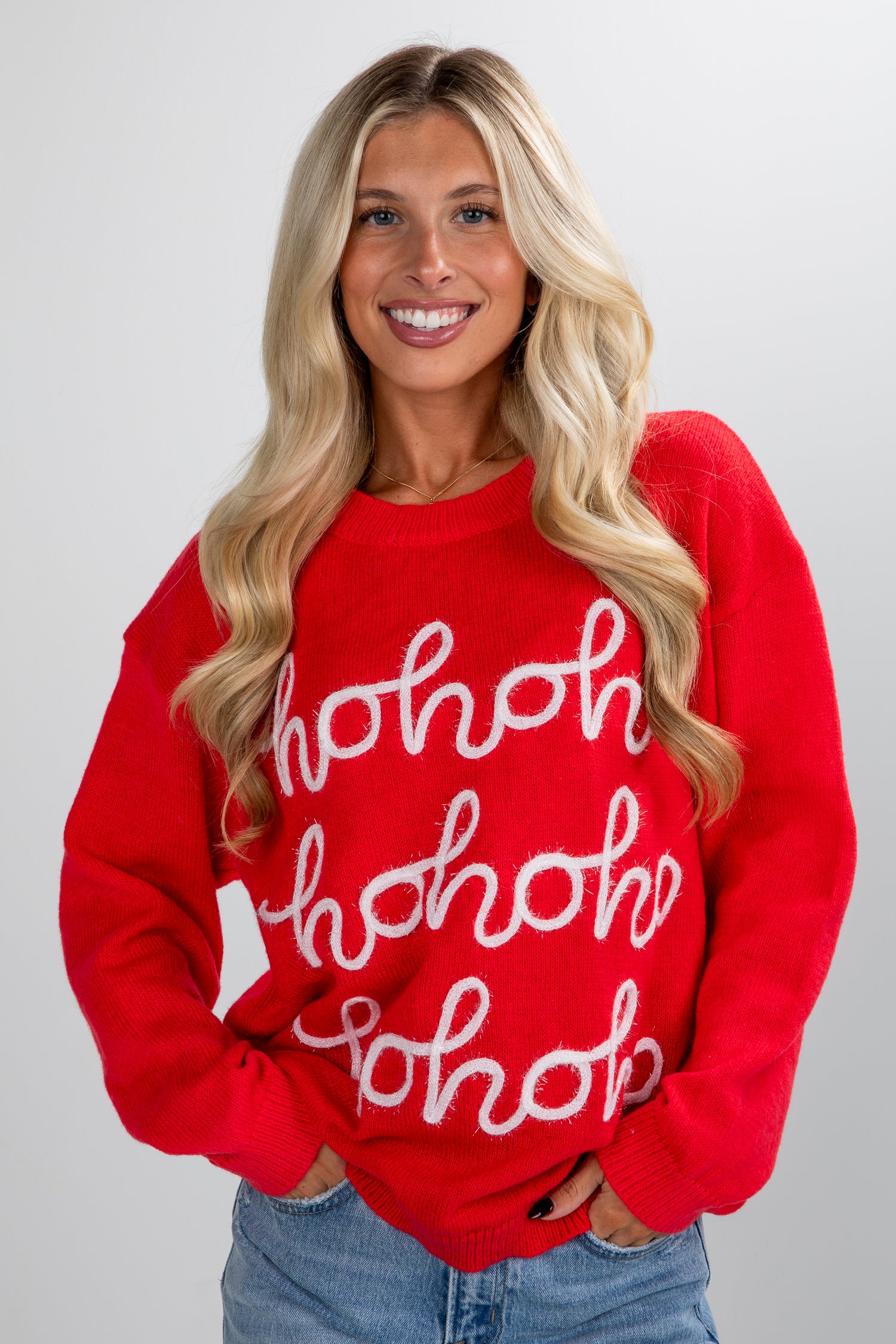 Woman wearing a red sweater with &