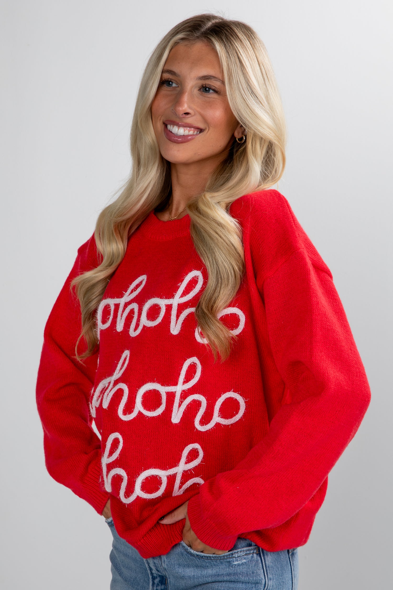 Woman wearing a red sweater with &