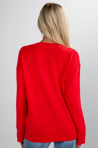 Person wearing a red sweater on a plain background