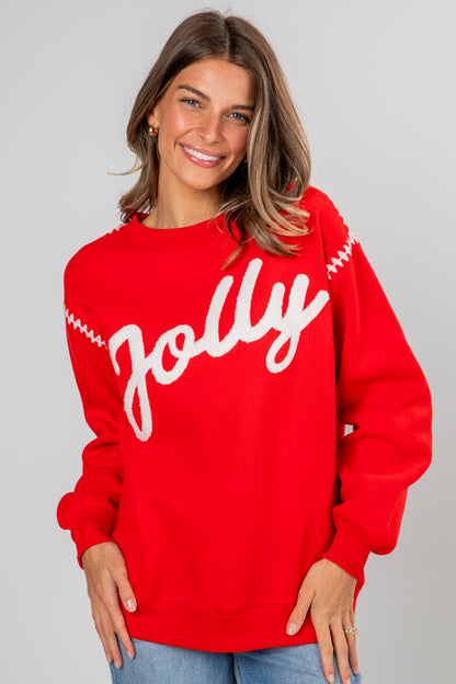 Woman wearing a red sweater with &