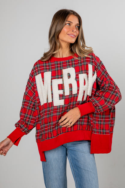 Woman wearing a red plaid sweater with &