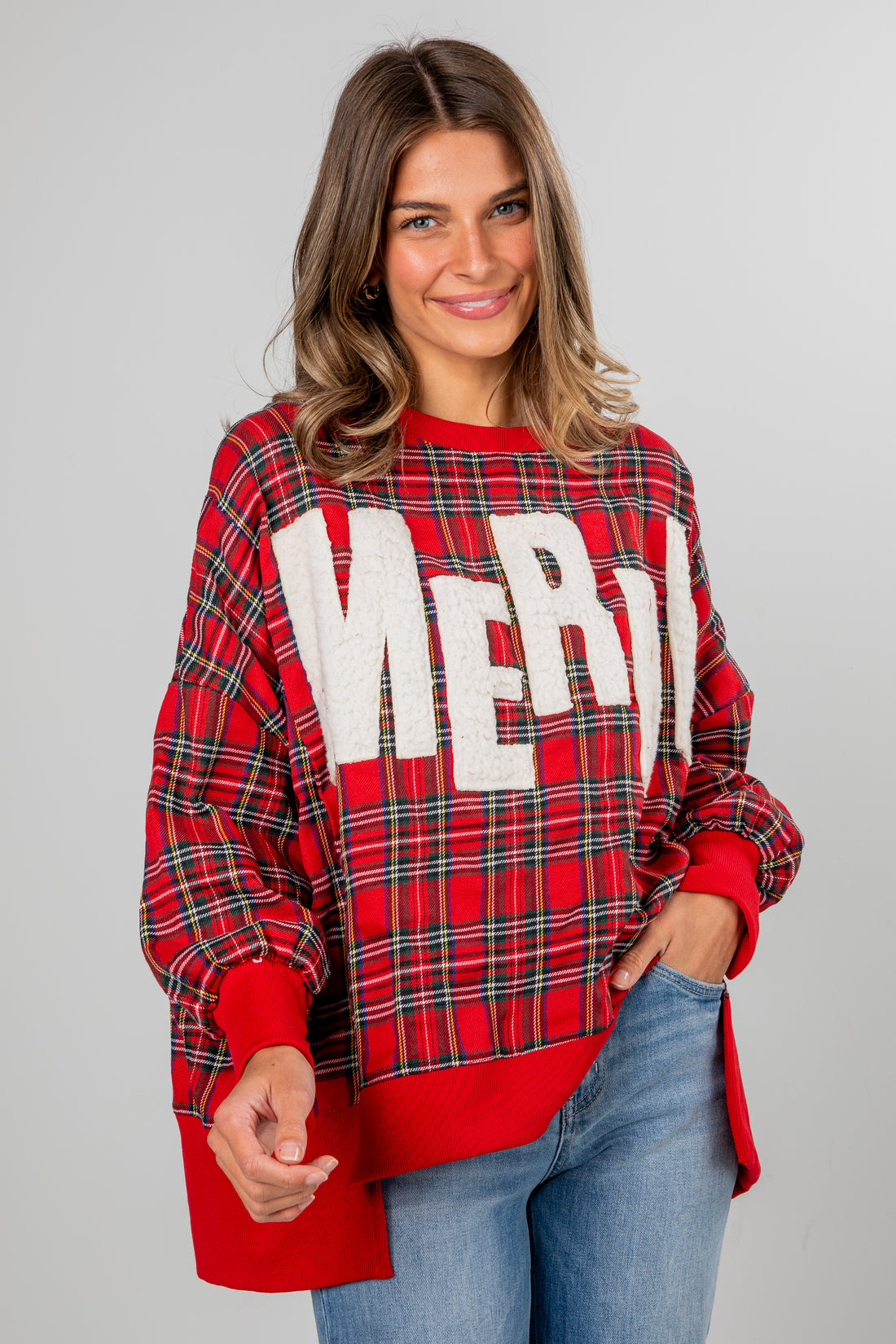 Woman wearing a red plaid sweater with &