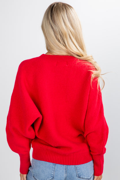 Person wearing a red sweater and blue jeans on a white background
