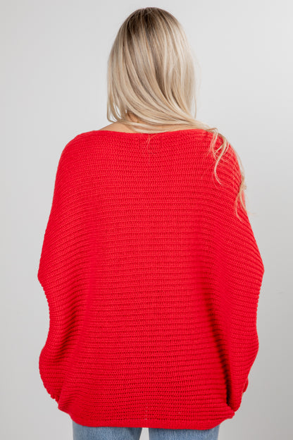 Person wearing a red sweater on a plain background