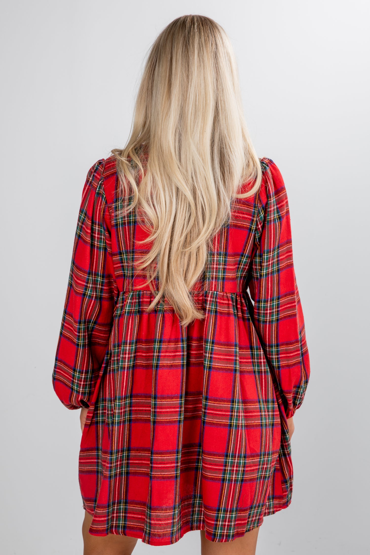 Red plaid dress worn by a person on a white background