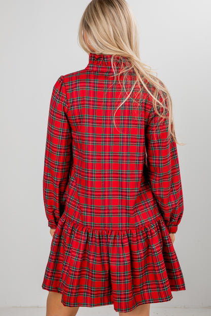Red plaid dress worn by a person with a plain background