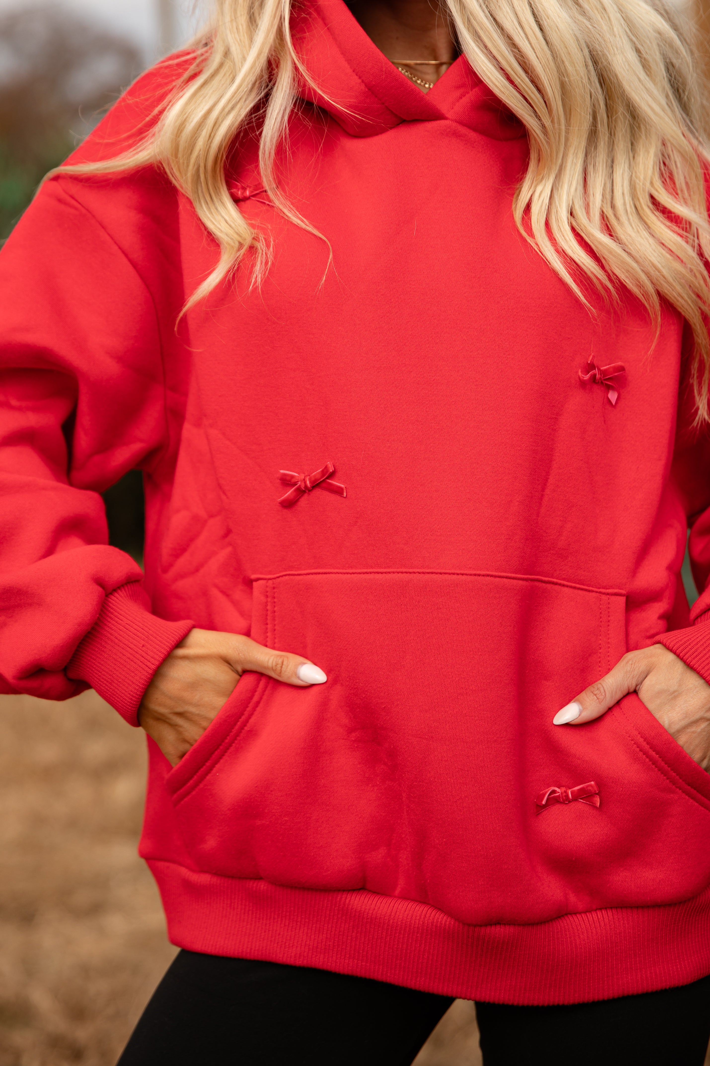 Red hoodie with small bows on a blurred background