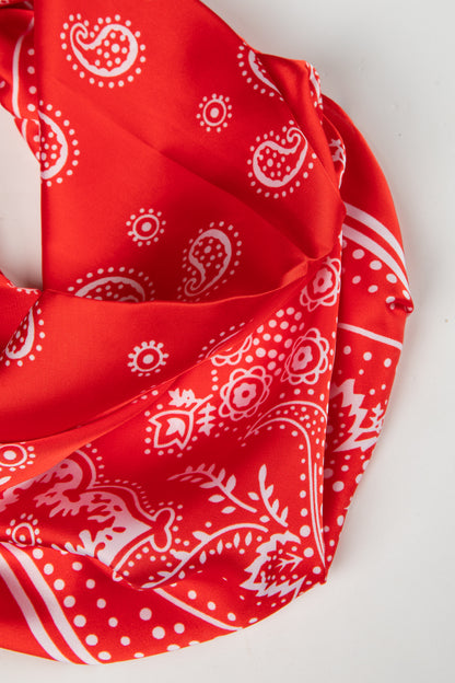 Red bandana with white paisley patterns on a white background