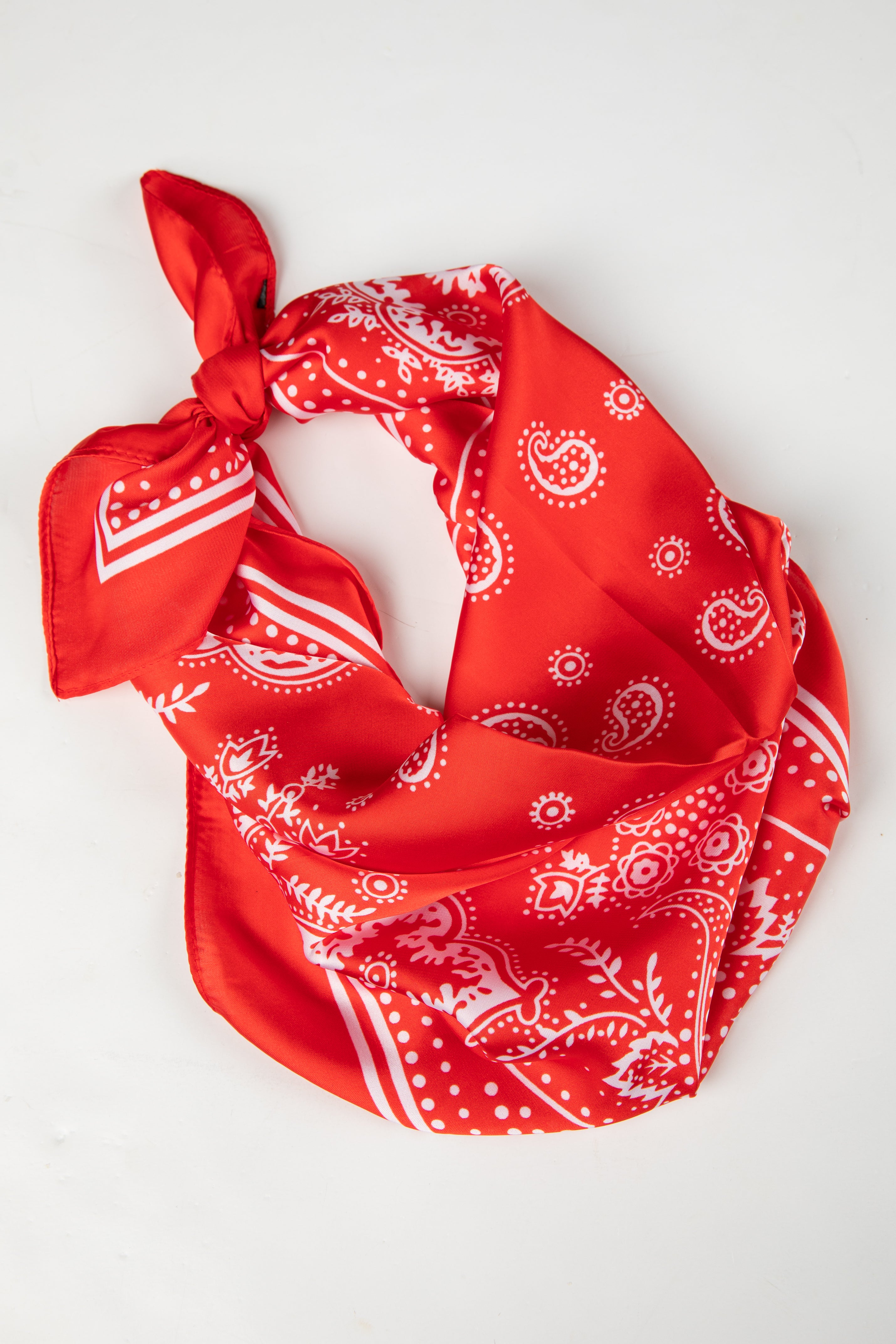 Red bandana with white patterns on a white background