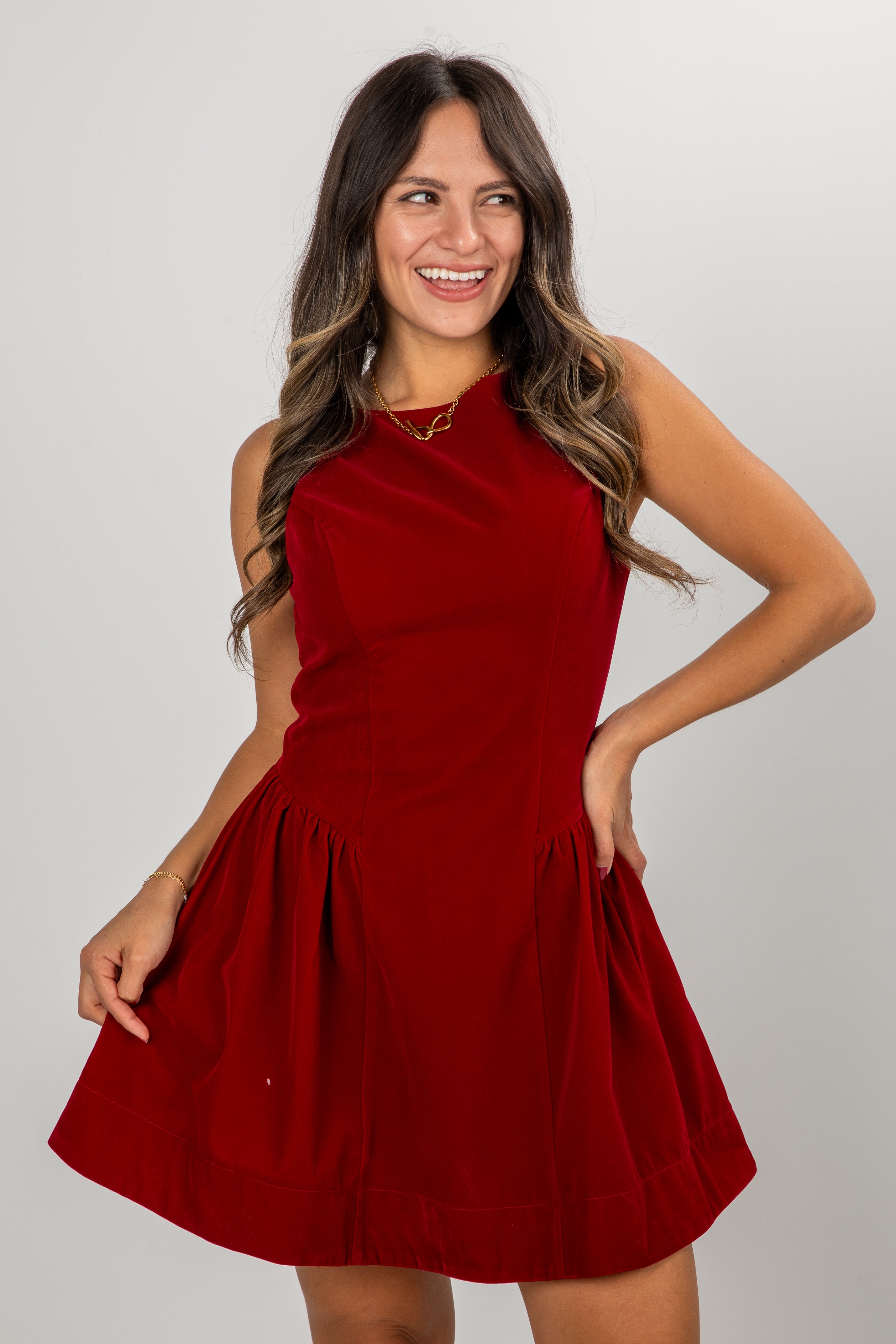 Woman wearing a red dress against a plain background