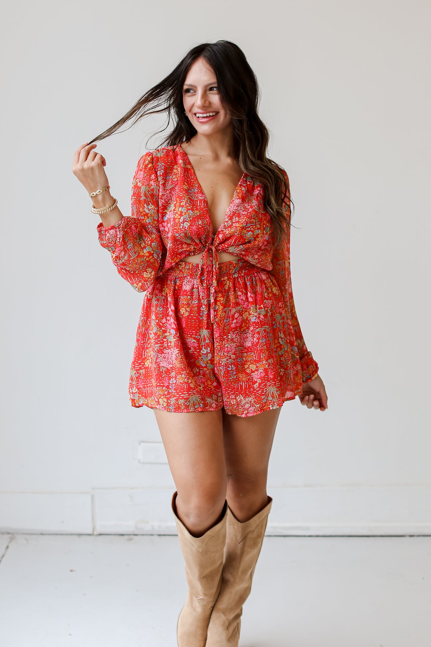 model wearing a red Floral Romper