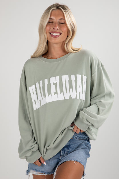 Woman wearing a green sweatshirt with &