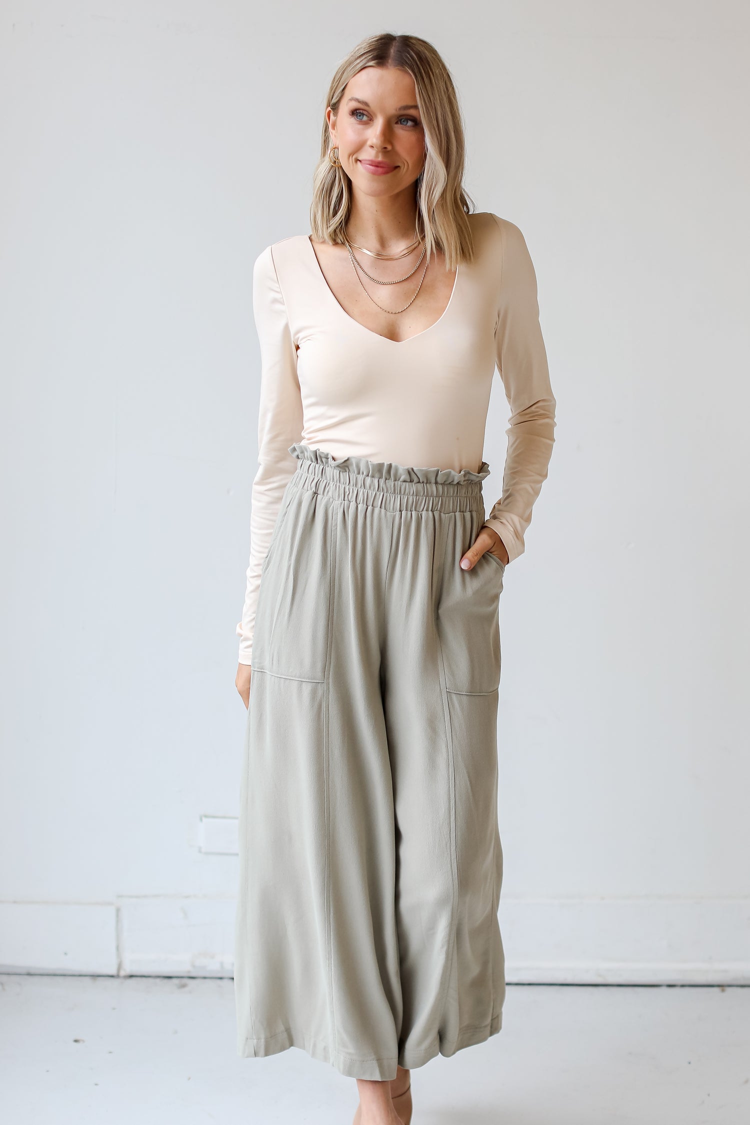sage Paperbag Waist Pants on model with taupe bodysuit