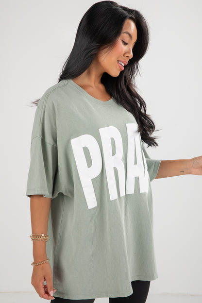 Woman wearing a green t-shirt with &