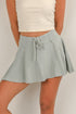Light green skirt worn by a person on a plain background