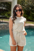 Woman wearing a striped romper by a pool