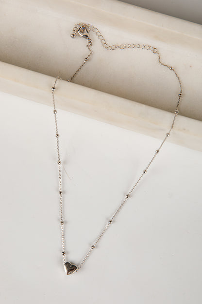 Necklace with a heart pendant on a light background