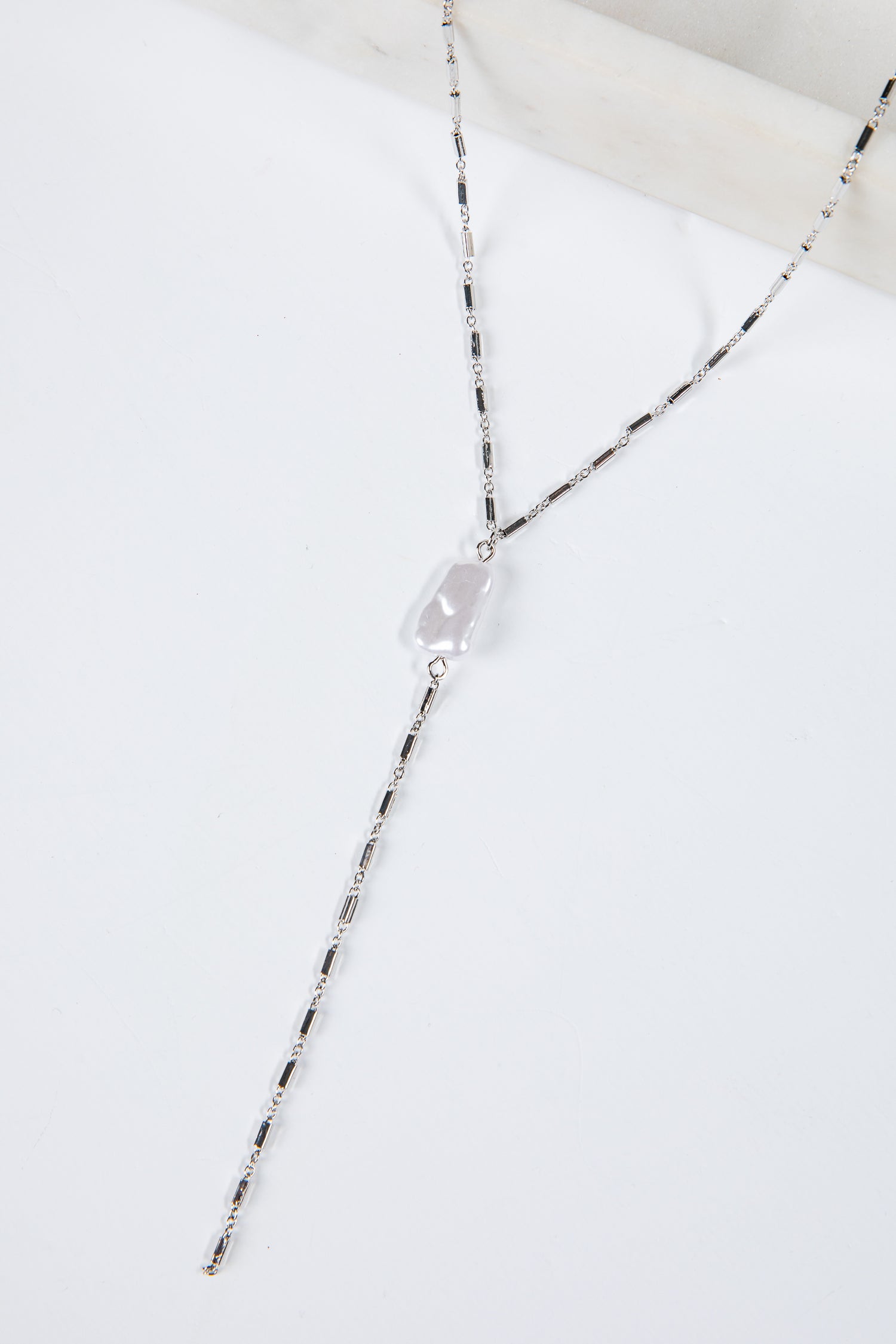 Necklace with a clear pendant on a white background