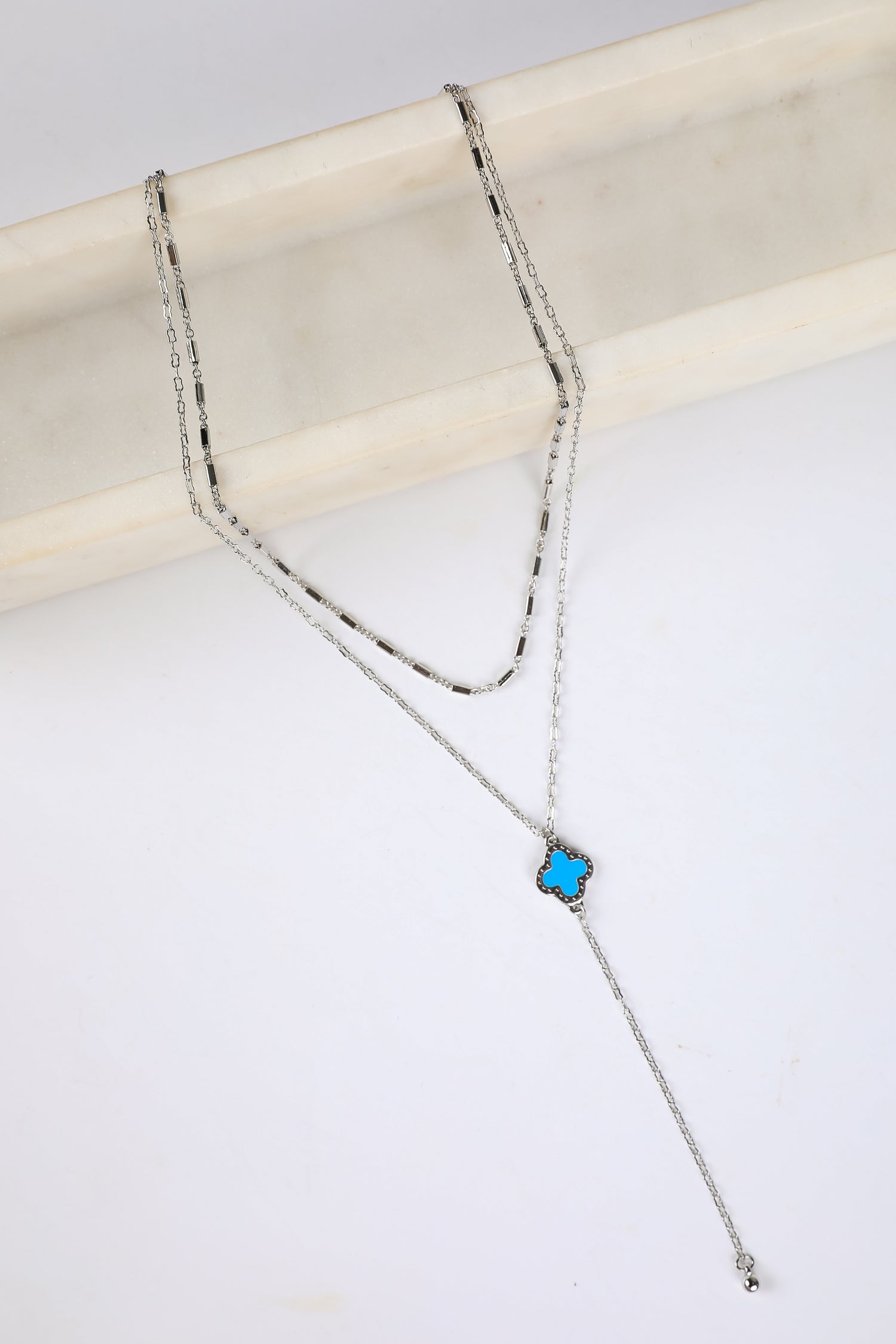 Necklace with a blue pendant on a white background