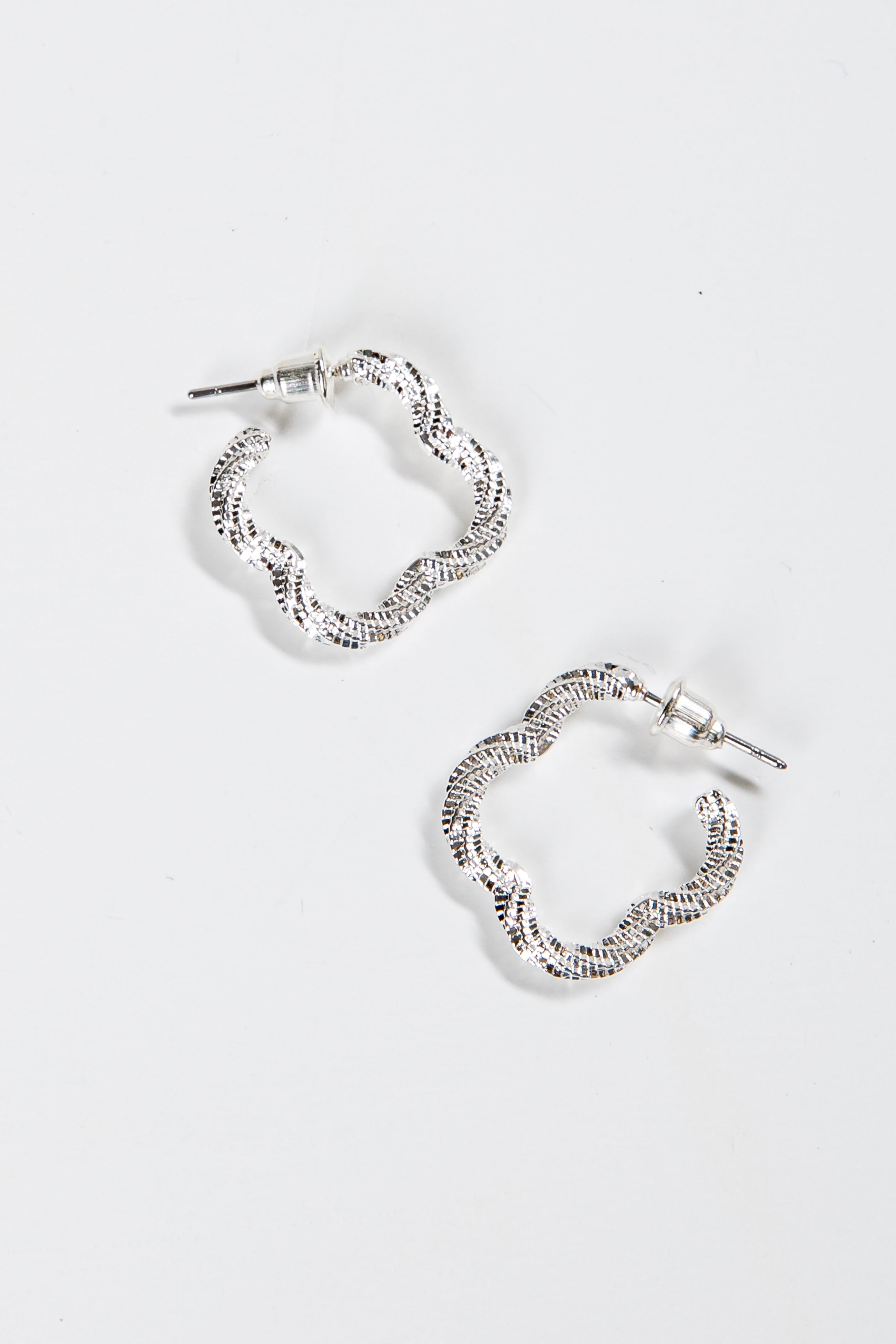 Pair of silver hoop earrings on a white background