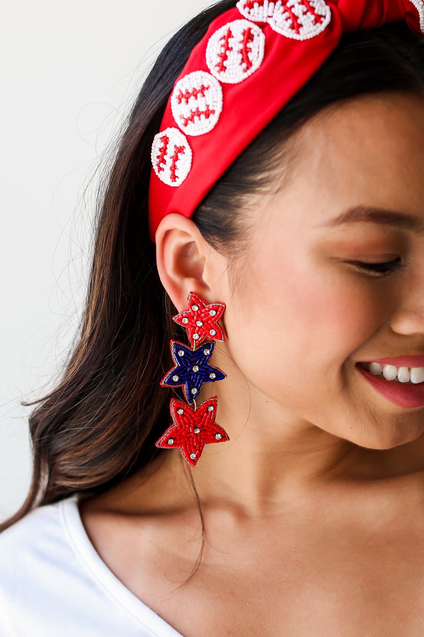 Red + Blue Beaded Star Drop Earrings on model