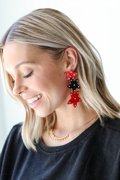 Red + Black Beaded Star Drop Earrings on dress up model