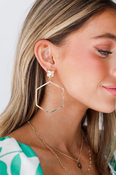 Gold Hexagon Drop Earrings on model