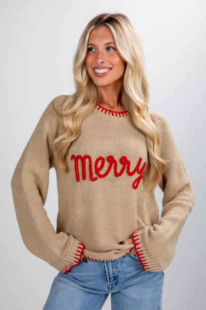 Woman wearing a beige sweater with &