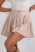 Beige skirt worn by a person on a white background