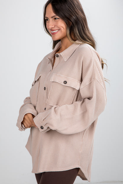 Woman wearing a beige corduroy shirt on a white background