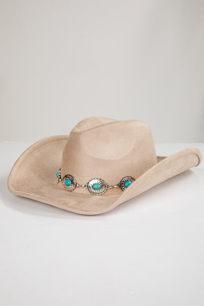 Beige cowboy hat with decorative band featuring turquoise stones on a light gray background