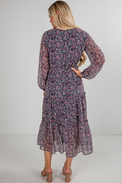 Woman wearing a floral dress with long sleeves on a white background