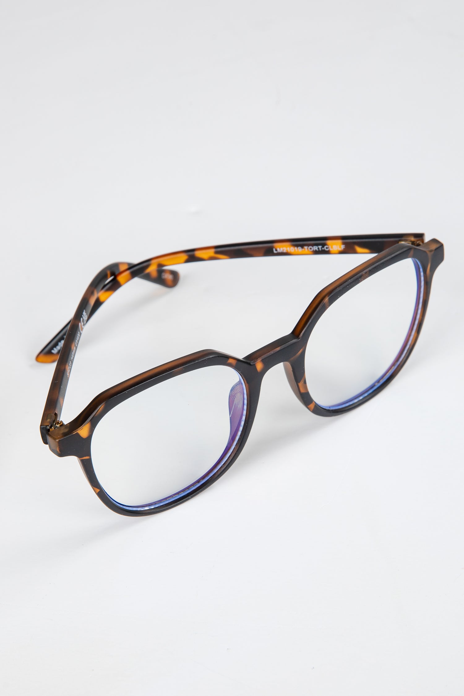 Tortoiseshell eyeglasses on a light gray background