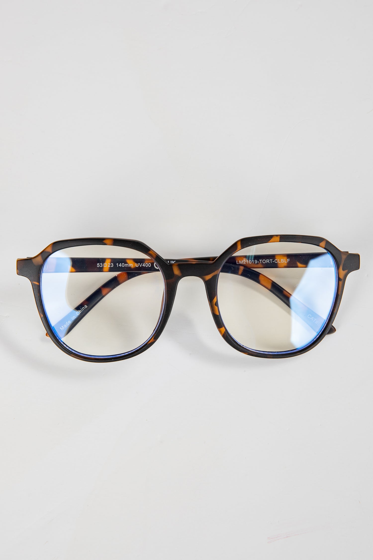 Tortoiseshell eyeglasses on a light gray background