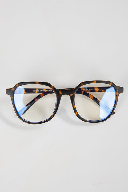 Tortoiseshell eyeglasses on a light gray background