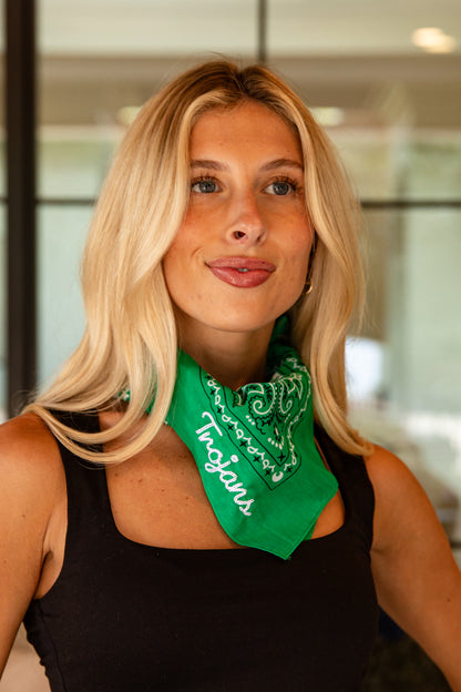 Woman wearing a green bandana with &