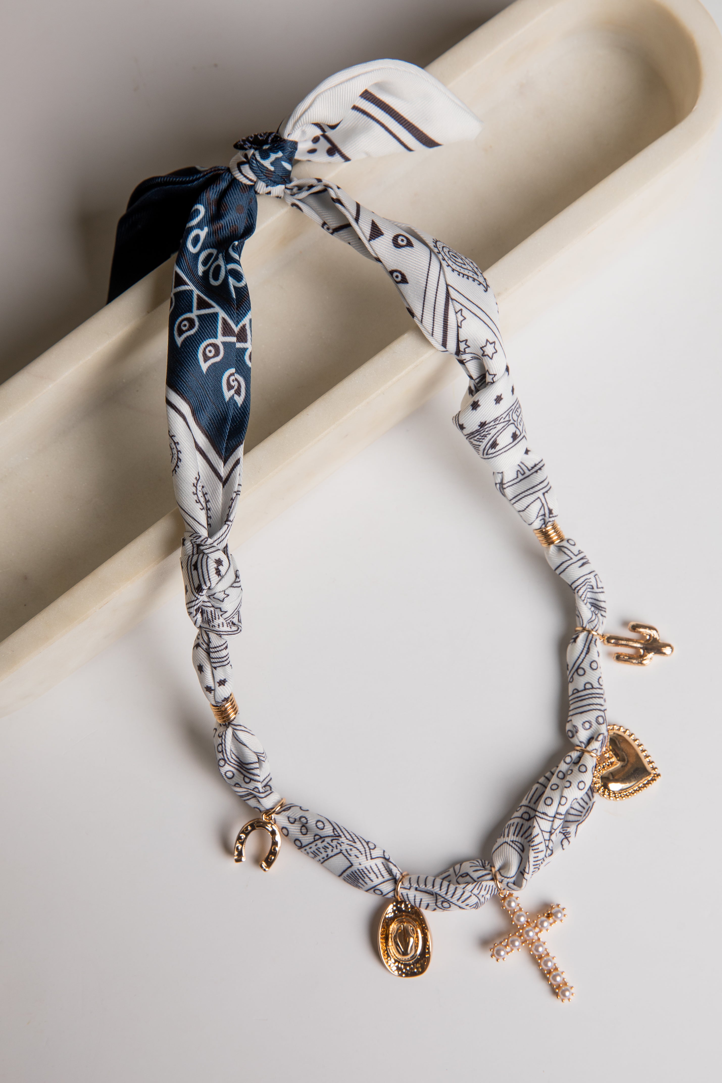 Necklace with charms on a white surface