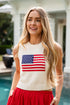 Woman wearing a sleeveless sweater with an American flag design outdoors.