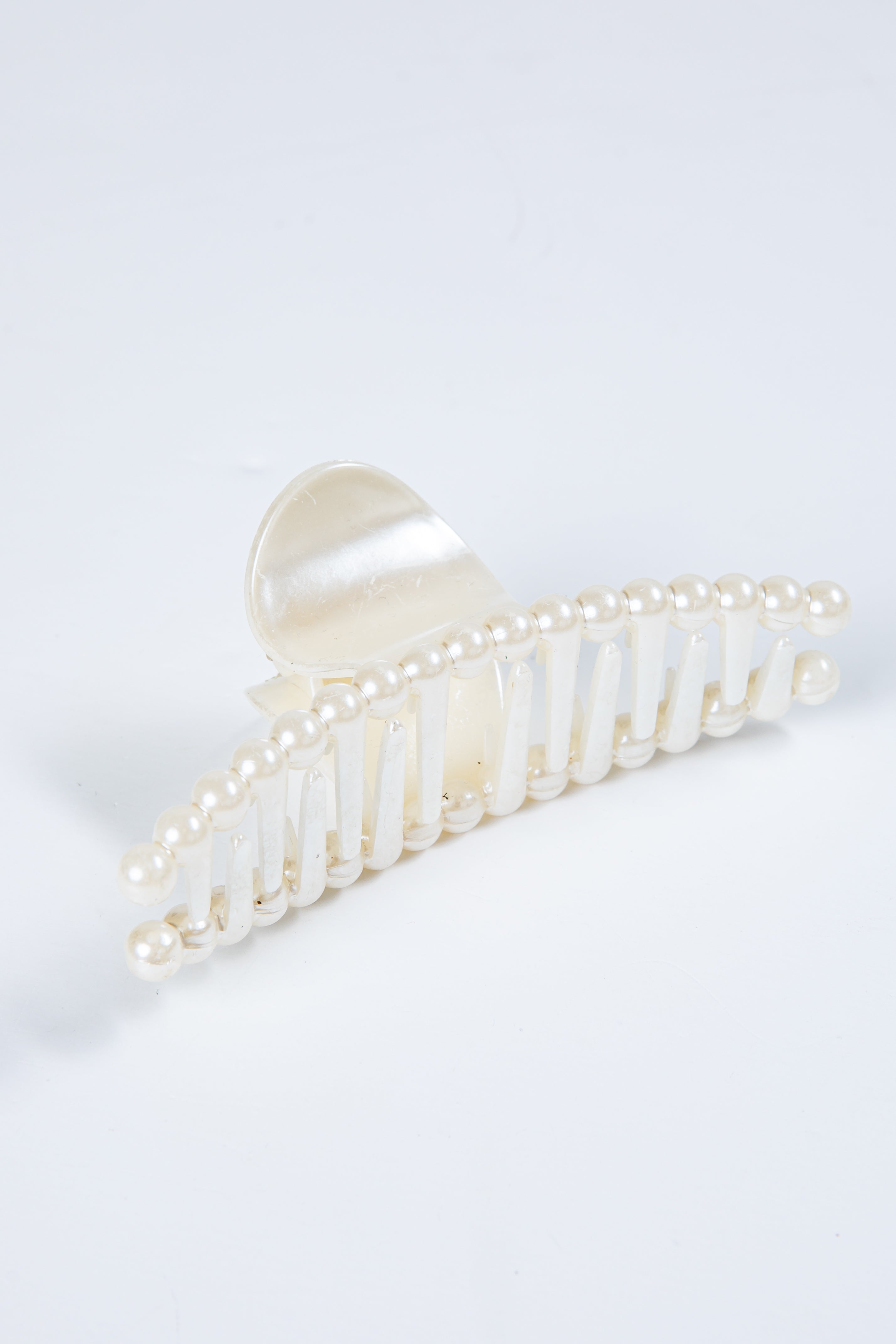 Pearl decorative hair clip on a white background