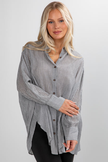 Woman wearing a checkered shirt on a plain background